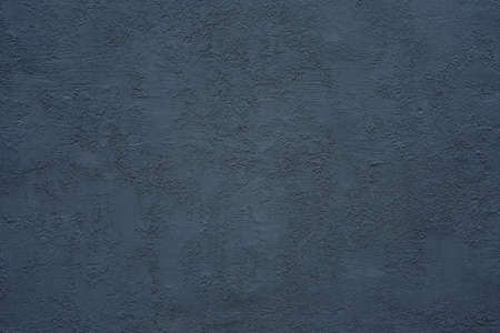 homogeneous coarse and rough texture plastered wall of dark blue color for background or wallpaperの写真素材