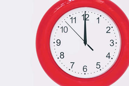 large of scarlet color analog clock show 12 hours at midnight or noon close-upの写真素材
