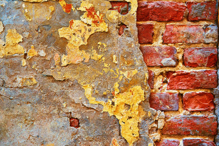 abstract part of an old brick wall with destroyed plaster for a vintage retro and loft style background and wallpaperの写真素材