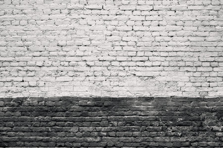 Old painted brick texture for background or wallpaper with two horizontal areas of different color surfaceの写真素材
