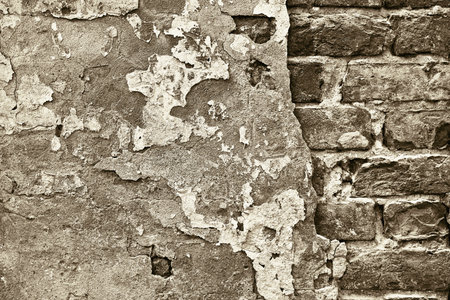 abstract part of the old brick wall with ruined plaster for vintage background and wallpaper in the style of sepiaの写真素材