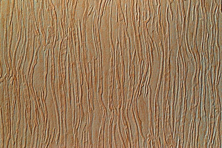 texture of textile material or fabric with winding abstract and coarse corrugated pattern for brown yellow background or wallpaperの写真素材