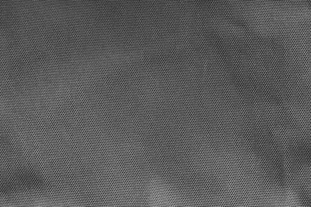 abstract grainy texture of coarse fabric for black background or wallpaperの写真素材