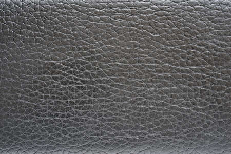 abstract and corrugated black leather texture close-up for background and wallpaperの写真素材