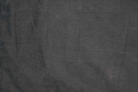 dark textured background of black coarse fabric or textileの写真素材