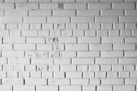 textured background of the white gray wall painted with old brick