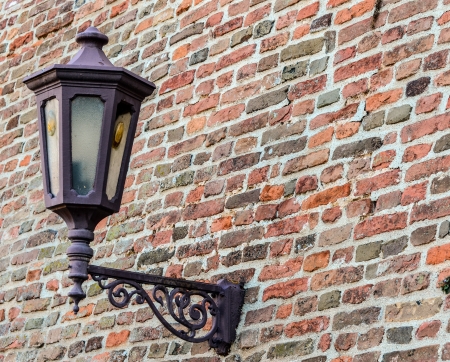 Old street lamp on brick wallの写真素材