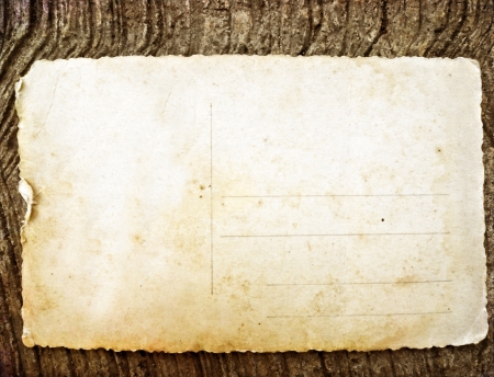 Old postcard on wallの写真素材