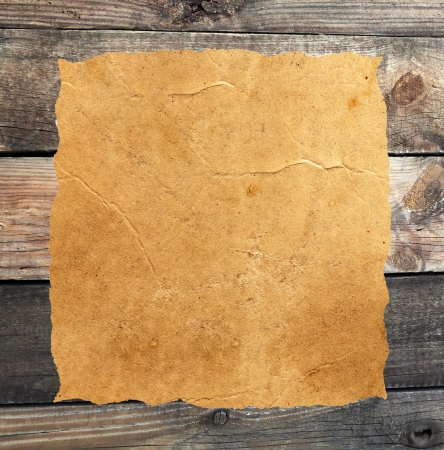 Empty grunge paper against wood backgroundの写真素材