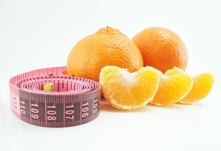tangerines and measure tape; isolated on white

の写真素材