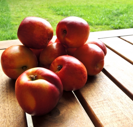 fresh peaches on wooden tableの写真素材