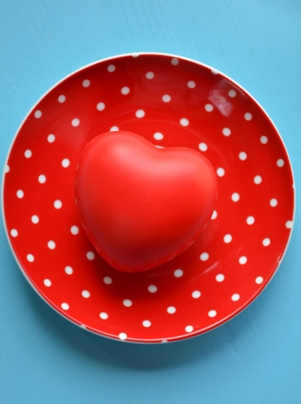  Heart on red plate of polka dots on blue backgroundの写真素材