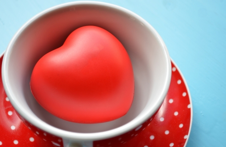 Red polka dot cup of coffee with heart の写真素材