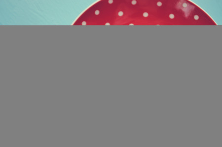 Red polka dot plate with heart vintageの写真素材