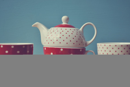 Red polka dots kettle with two cup of tea retroの写真素材
