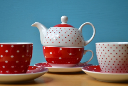 Red polka dots kettle with two cup of teaの写真素材