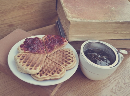 Vintage cup of tea with books and Grandma's cakeの写真素材