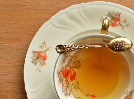 Cup of tea and teaspoon on woodenの写真素材