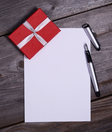 Blank paper with gift on woodenの写真素材