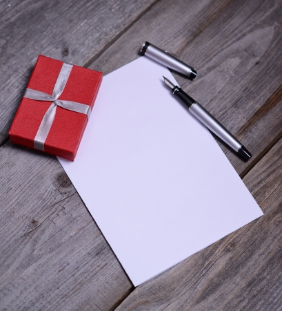Blank paper with pencil and small red boxの写真素材