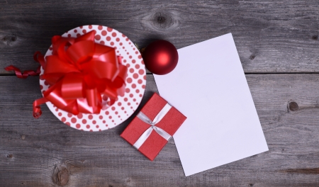 Christmas Presents and Ornaments on Wooden Background with blank paperの写真素材
