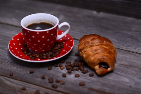 Coffee and croissant on wooden backgroundの写真素材