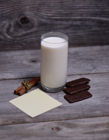 Glass of milk with cinnamon with paperの写真素材