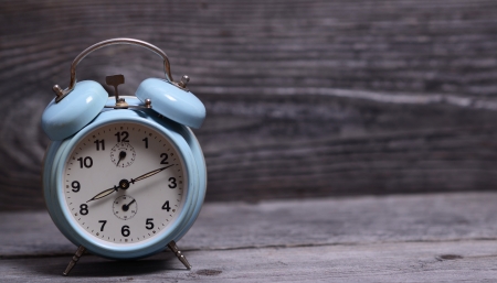 Retro turquoise clock on wooden backgroundの写真素材