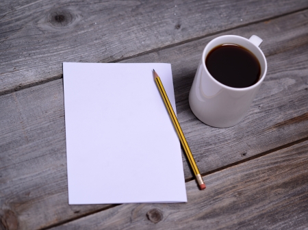 White mug of coffee and blank paperの写真素材