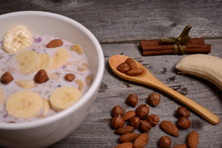 bowl of muesli and millk with fresh banana close upの写真素材