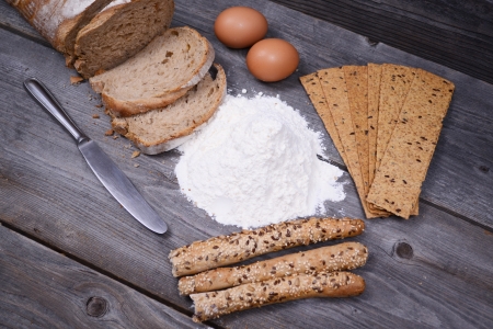 fresh bread, eggs and flax chips on the woodenの写真素材