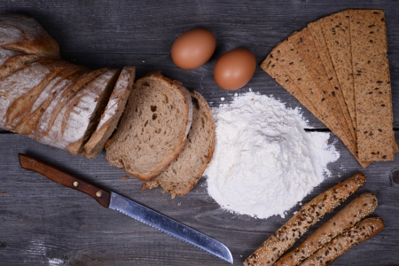 fresh bread, eggs and flax chips on the woodenの写真素材