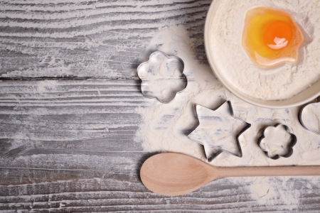 homemade baking closeup and cookie cutters on woodenの写真素材