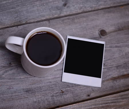 Mug of coffee with photo paperの写真素材