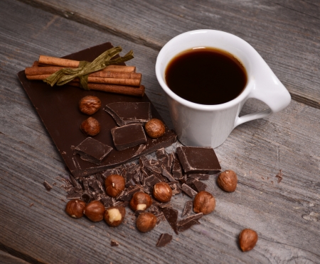 Pieces of dark chocolate, cinnamon and cup of coffeeの写真素材