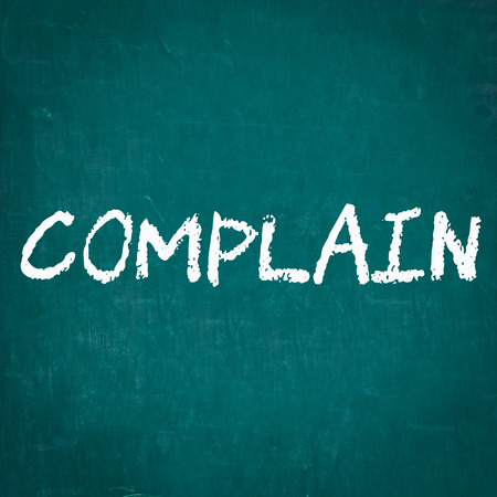 COMPLAIN written on chalkboardの写真素材