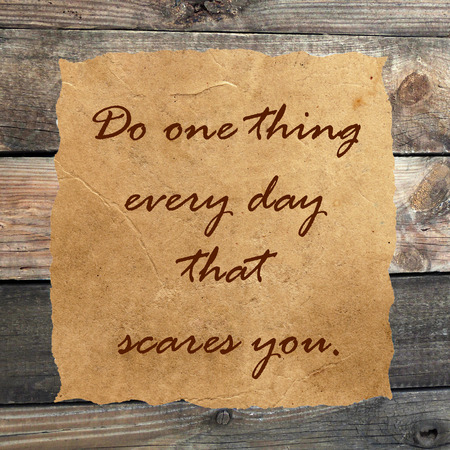 Inspirational quoteon  grunge paper against wood backgroundの写真素材