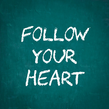 FOLLOW YOUR HEART written on chalkboardの写真素材