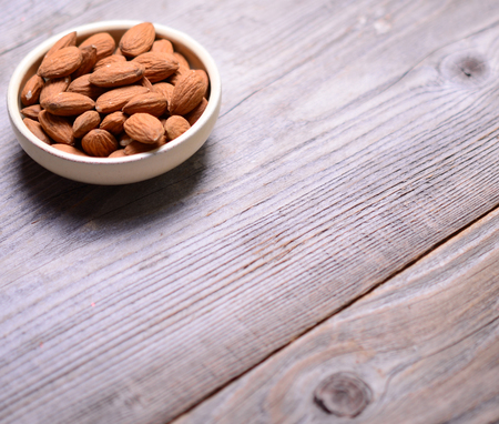 Almonds on wooden backgroundの写真素材