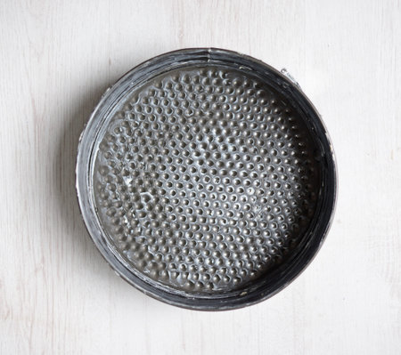 a round backing mold is greased with margarine