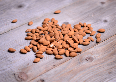 Almonds on wooden backgroundの写真素材