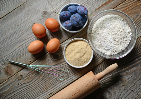 Baking plum cake in rural kitchenの写真素材