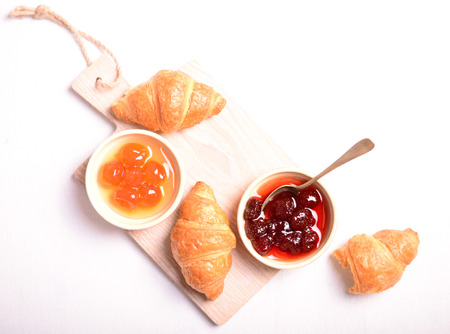 Breakfast with fresh croissants and fresh jam on white backgroundの写真素材