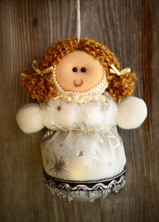 Christmas doll ornament on wood backgroundの写真素材