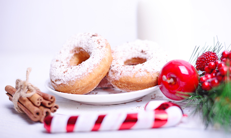 Christmas donuts on white wooden table closeupの写真素材