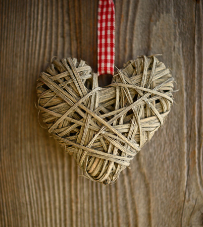 Christmas heart ornament on wood backgroundの写真素材