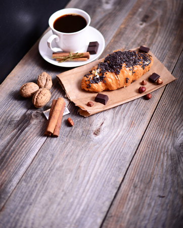 Chocolate croissant with coffee on tableの写真素材