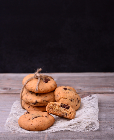 Chocolate cookies on lace napkin on old tableの写真素材