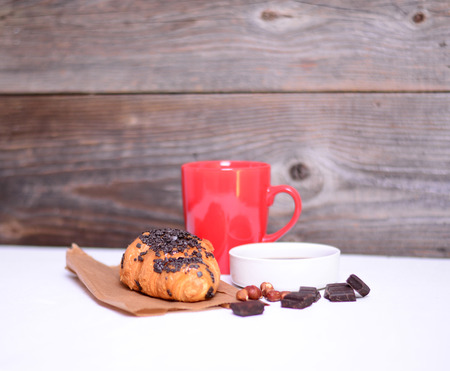 Chocolate croissant on white wooden backgroundの写真素材