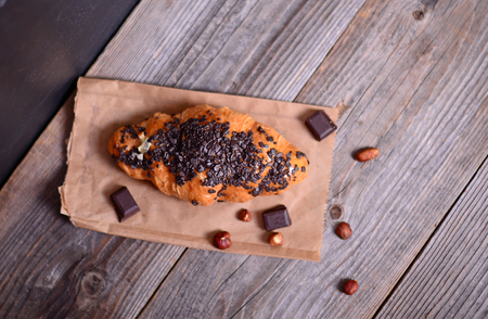 Chocolate croissant on wooden backgroundの写真素材